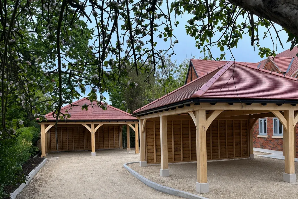 Bespoke oak framed garage illuminated at dusk